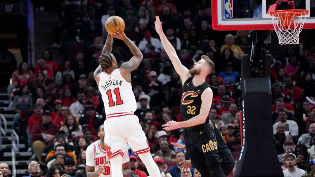 Feb 28, 2024; Chicago, Illinois, USA; Cleveland Cavaliers forward Dean Wade (32) defends Chicago Bulls forward DeMar DeRozan (11) during the second half at United Center. Mandatory Credit: David Banks-USA TODAY Sports